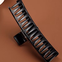 a black hair comb on a brown background